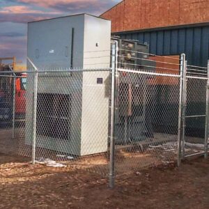 Chain link fence installed around a power unit. Commercial fencing in Lethbridge provided by DH fencing