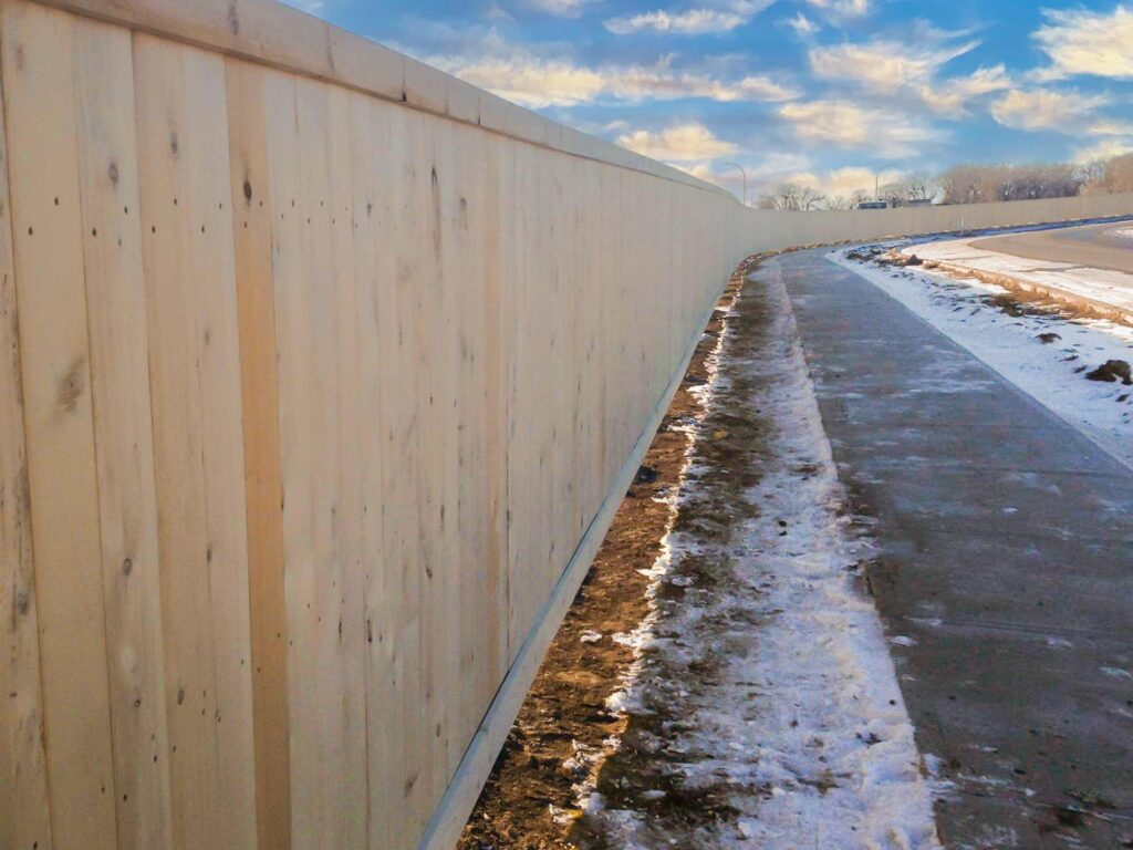 commercial wood fencing installed in a new community. Commercial fencing in Lethbridge provided by DH fencing